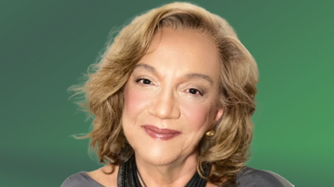  A portrait of a woman, against a green background.