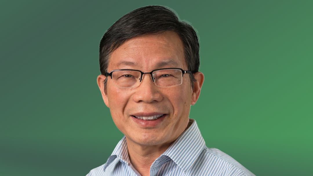  A man with glasses looks into the camera.